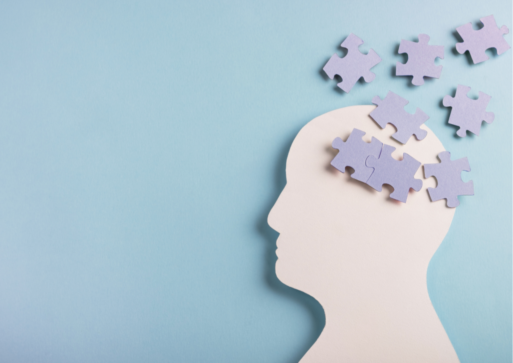 Image creatively detailing a neurodiverse brain using puzzle pieces coming out of a head